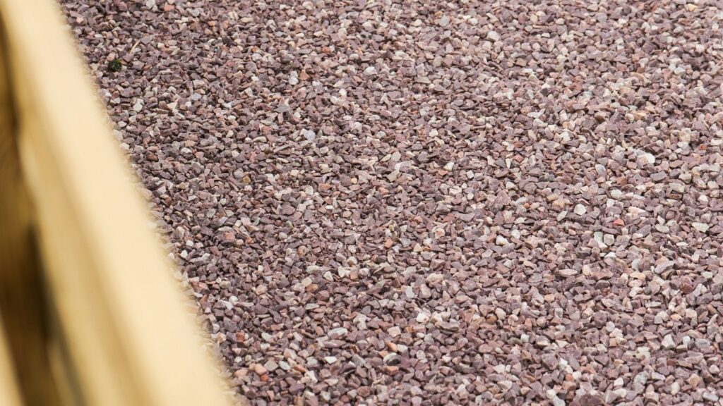rood grind heritage oprit met betonnen afgeschuinde borduren en houtsnippers